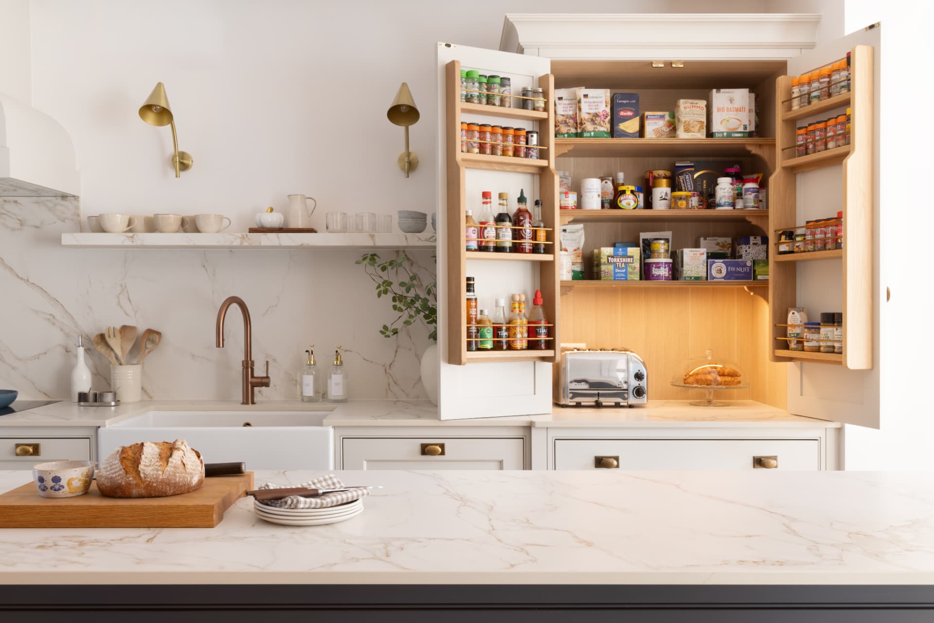 Lake Geneva House — open pantry cupboard revealing oak shelving, spice racks and concealed lighting