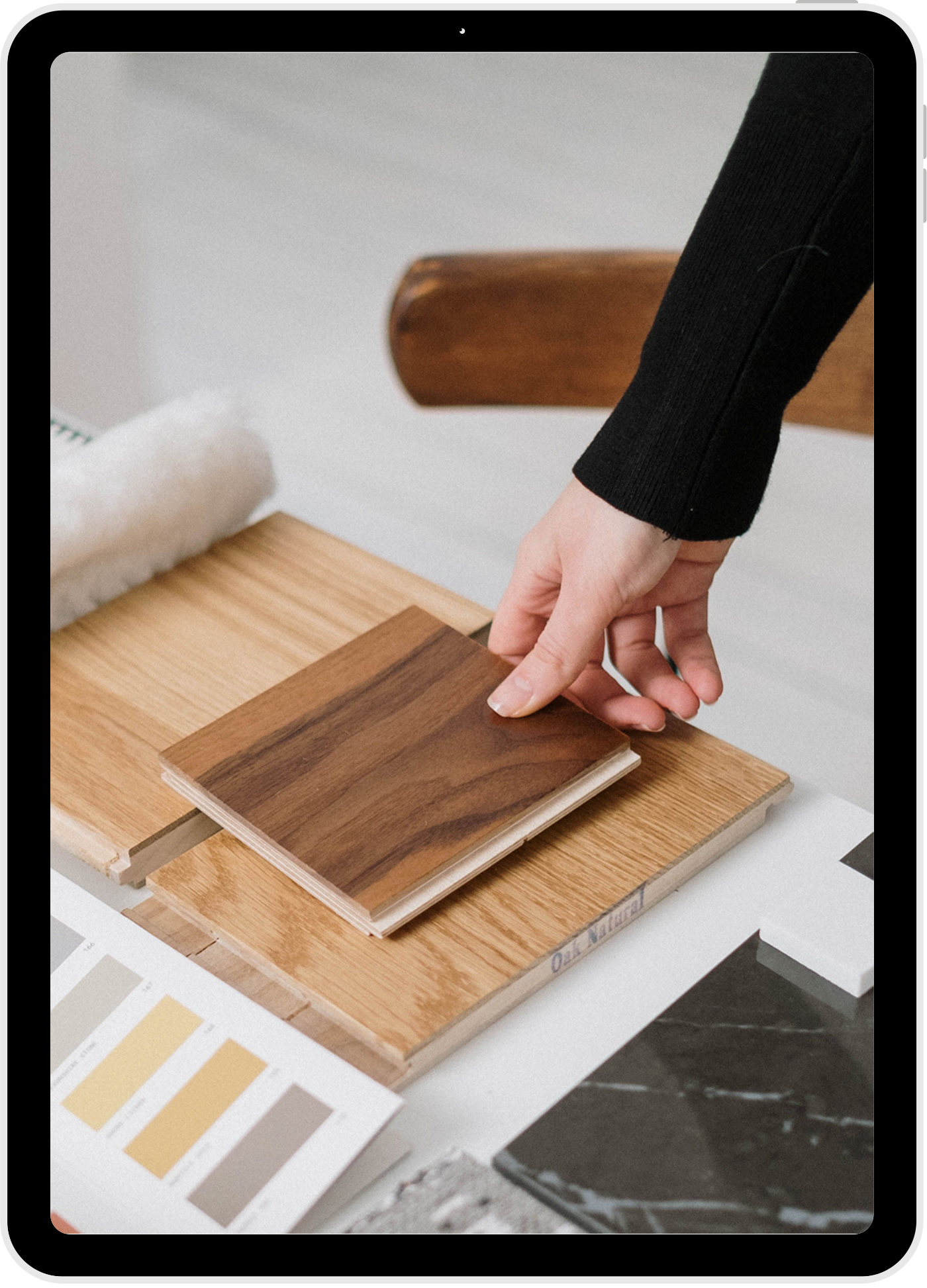 B&A Interiors material selection — oak and walnut samples with a paint palette