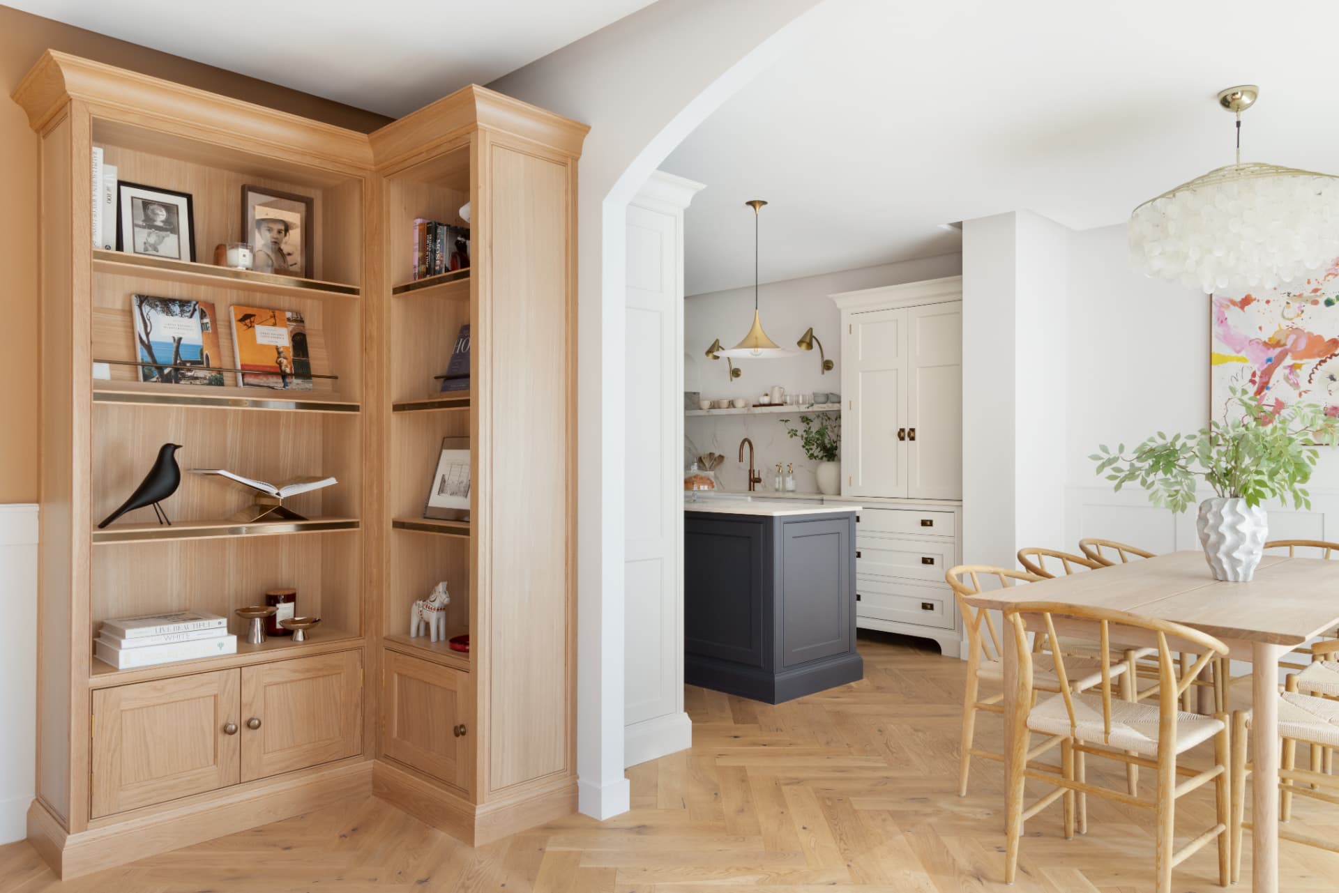Lake Geneva House — oak corner library beside an arched opening between the kitchen and dining room